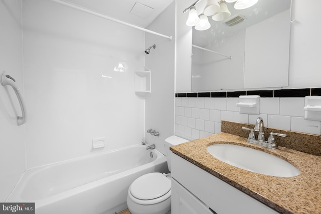 full bath featuring vanity, visible vents, shower / washtub combination, tile walls, and toilet