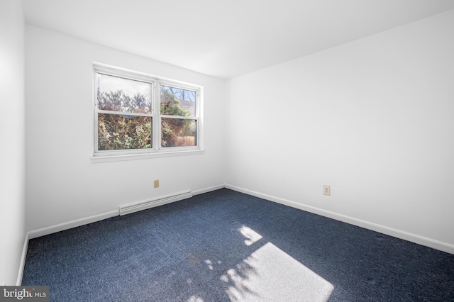 spare room featuring baseboards, dark colored carpet, and a baseboard radiator