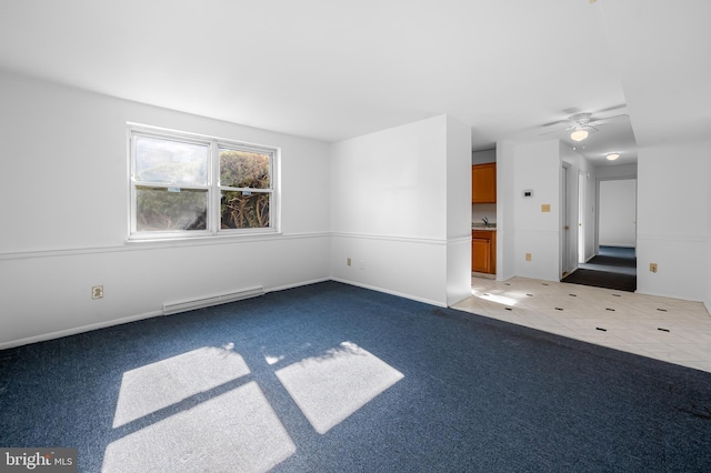 carpeted empty room featuring a baseboard heating unit, baseboards, and ceiling fan