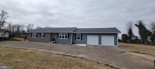 single story home with aphalt driveway, a garage, roof with shingles, and a front yard