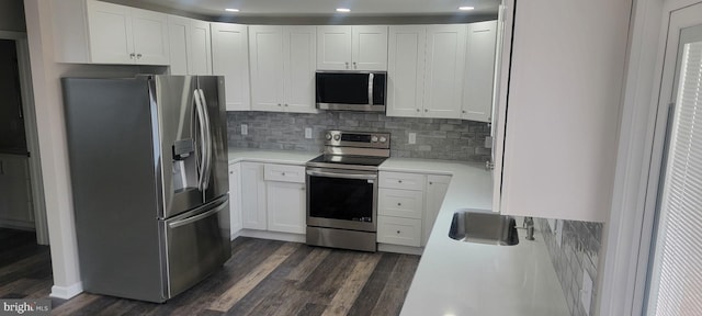 kitchen featuring white cabinetry, light countertops, dark wood-style floors, and appliances with stainless steel finishes