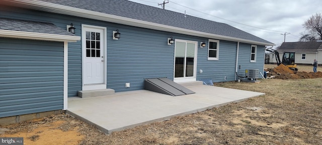 rear view of house with central air condition unit, roof with shingles, and entry steps