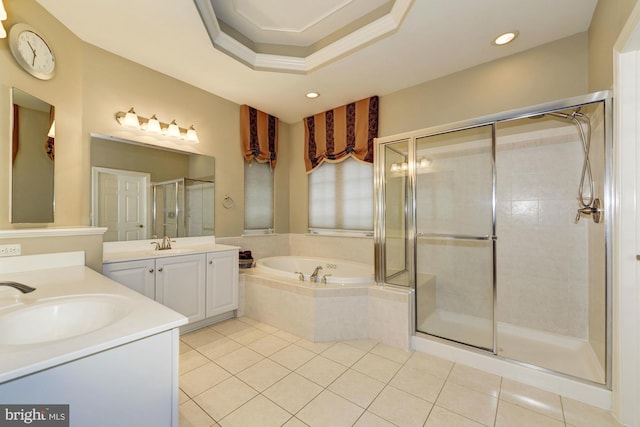 bathroom featuring tile patterned floors, a garden tub, two vanities, a sink, and a shower stall