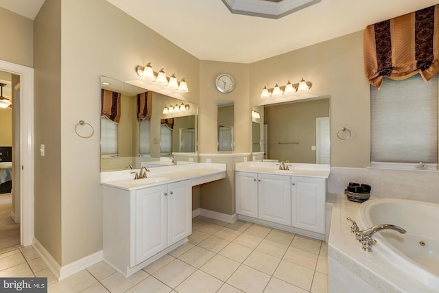 full bath with tile patterned floors, a jetted tub, two vanities, and a sink