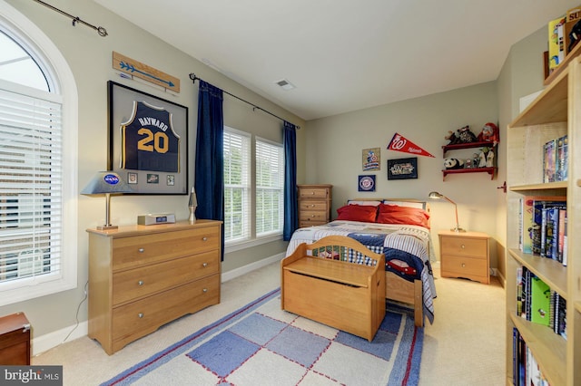 carpeted bedroom featuring visible vents and baseboards