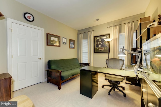 carpeted office space featuring visible vents