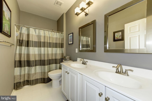 full bathroom with double vanity, toilet, visible vents, and a sink