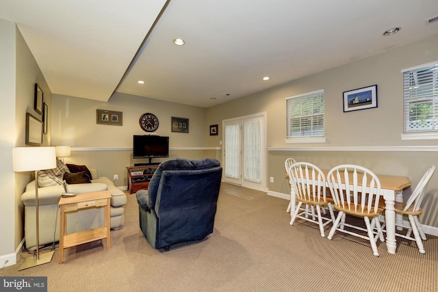 carpeted living area with recessed lighting, visible vents, and baseboards