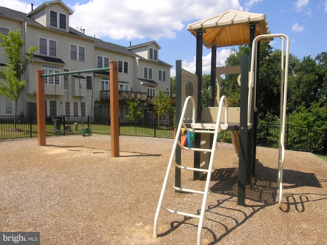 community jungle gym featuring fence and a residential view