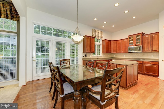 dining area with recessed lighting and light wood-style floors