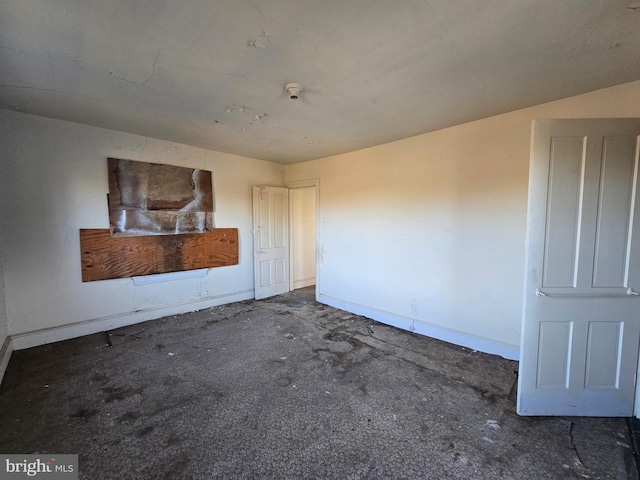 unfurnished living room featuring baseboards