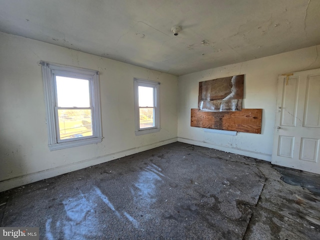 empty room featuring baseboards