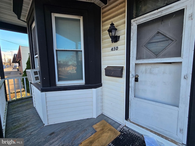 entrance to property featuring cooling unit and covered porch