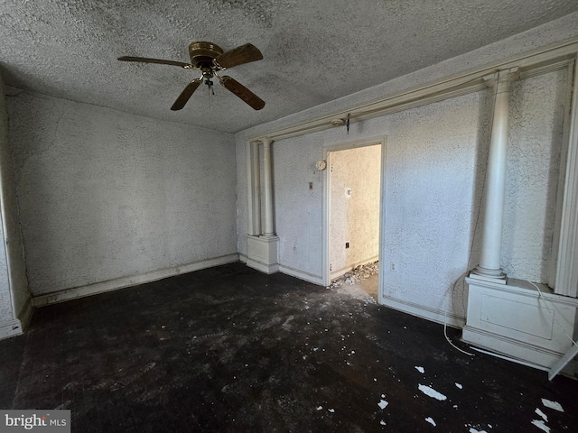 unfurnished room with a textured ceiling and a ceiling fan