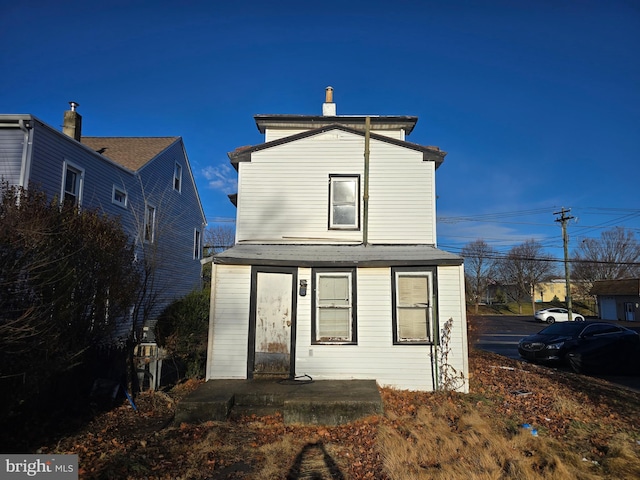 back of property featuring a chimney