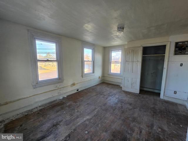 unfurnished bedroom with a closet and wood finished floors