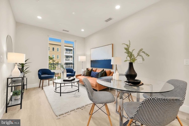 living area featuring visible vents, recessed lighting, and light wood-style floors