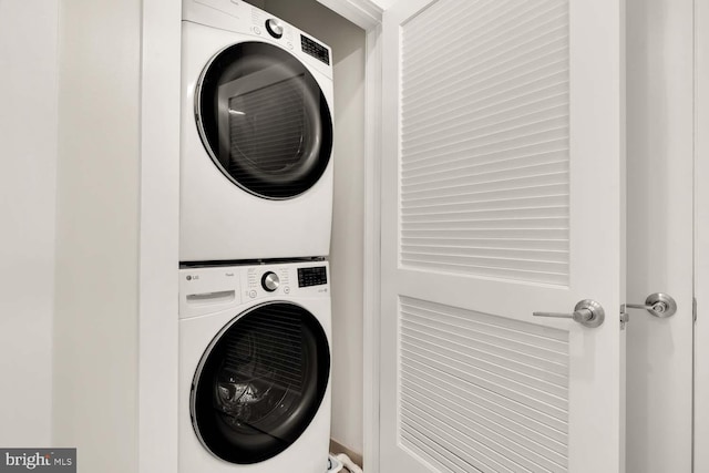 washroom with laundry area and stacked washer / dryer