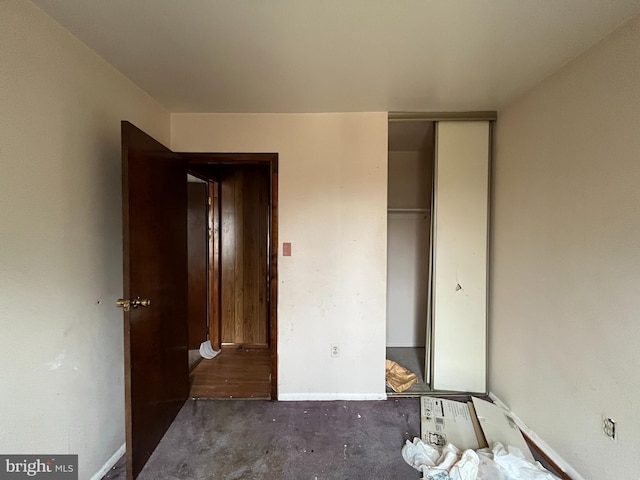 unfurnished bedroom with a closet and baseboards