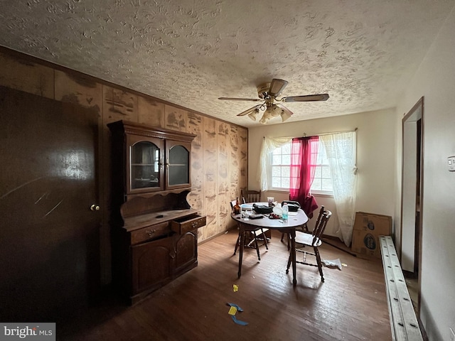 dining space featuring a textured ceiling, ceiling fan, and hardwood / wood-style flooring