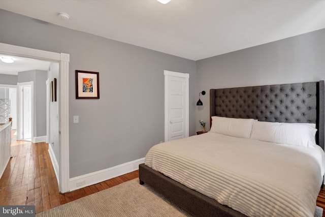 bedroom with baseboards and hardwood / wood-style floors