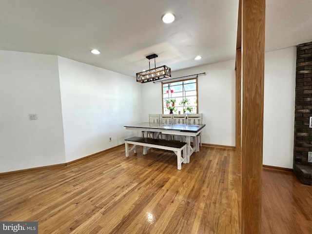 dining area with a notable chandelier, recessed lighting, baseboards, and light wood-style floors