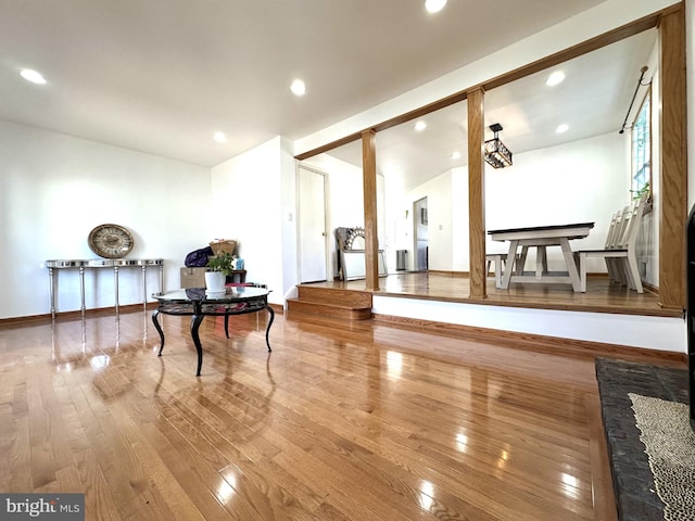 interior space featuring recessed lighting, baseboards, and wood finished floors