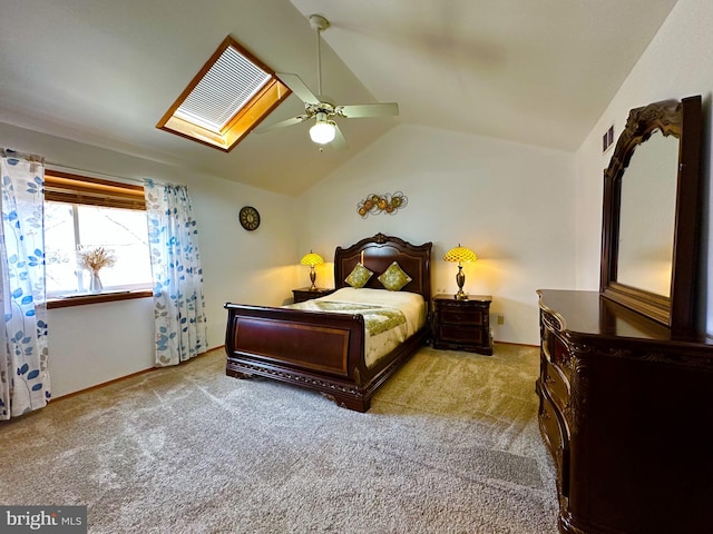 carpeted bedroom with vaulted ceiling with skylight, visible vents, and ceiling fan