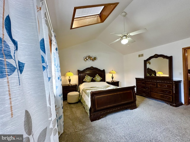 bedroom with lofted ceiling with skylight, visible vents, ceiling fan, and carpet