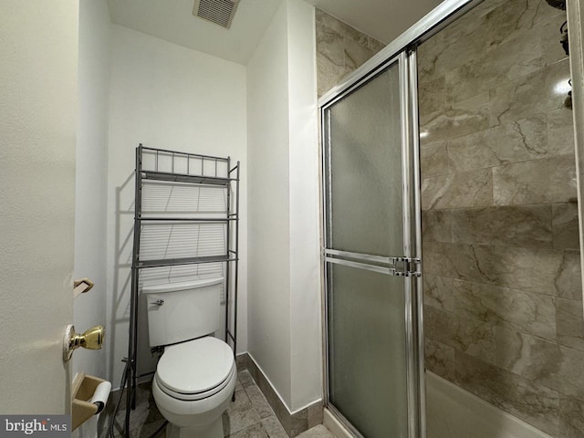 bathroom with visible vents, a stall shower, toilet, and baseboards