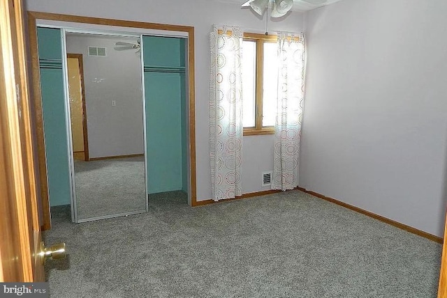 unfurnished bedroom with visible vents, baseboards, a closet, and carpet flooring