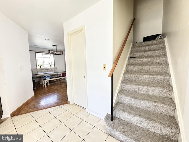 stairs featuring tile patterned flooring