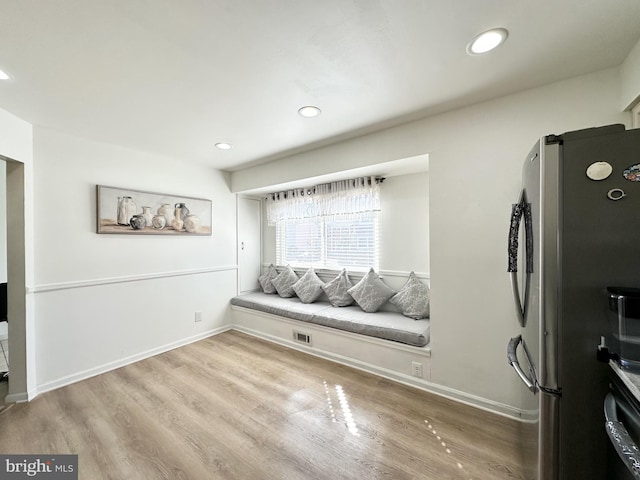 living area with recessed lighting, wood finished floors, and baseboards