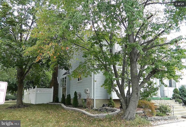 view of home's exterior with fence