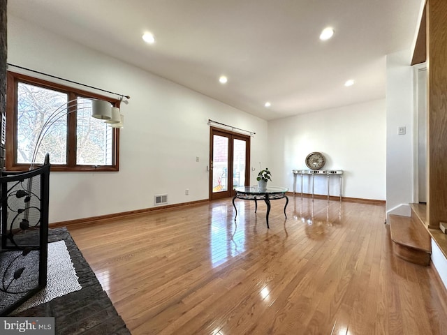 entrance foyer with light wood-style floors, visible vents, french doors, and baseboards