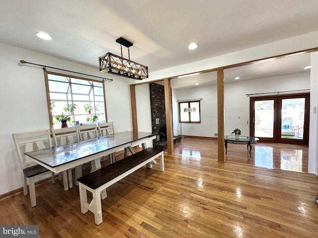 dining area with light wood finished floors, recessed lighting, and french doors