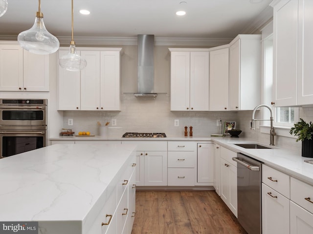 kitchen featuring white cabinets, appliances with stainless steel finishes, wall chimney exhaust hood, and a sink