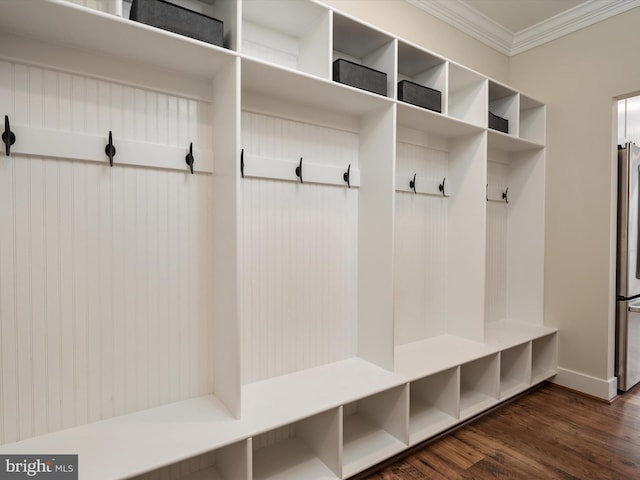 mudroom featuring dark wood finished floors, baseboards, and ornamental molding