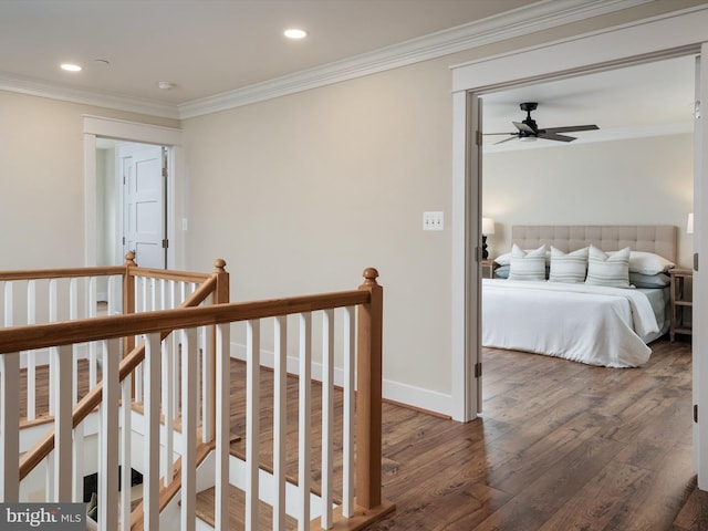 hall featuring an upstairs landing, ornamental molding, wood finished floors, recessed lighting, and baseboards