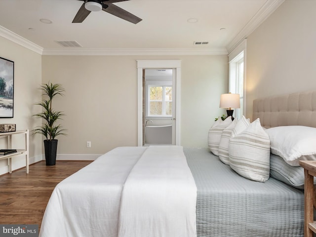 bedroom with dark wood-style floors, baseboards, visible vents, and ornamental molding