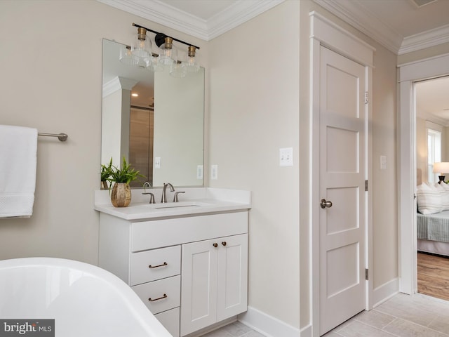 full bath featuring vanity, baseboards, a freestanding bath, crown molding, and connected bathroom