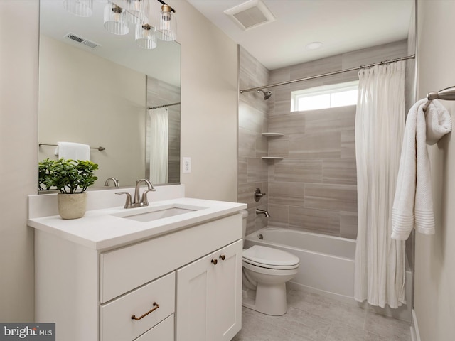 full bath with visible vents, toilet, vanity, and shower / tub combo with curtain