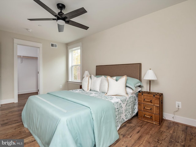 bedroom featuring visible vents, baseboards, a closet, and wood finished floors