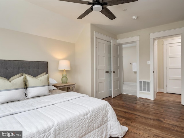 bedroom with ceiling fan, visible vents, baseboards, and wood finished floors