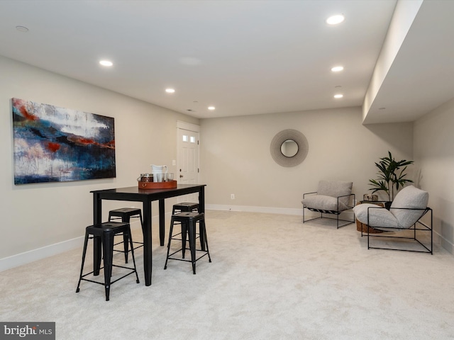 carpeted dining space with recessed lighting and baseboards