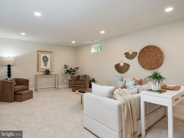 living area with light carpet, recessed lighting, and baseboards