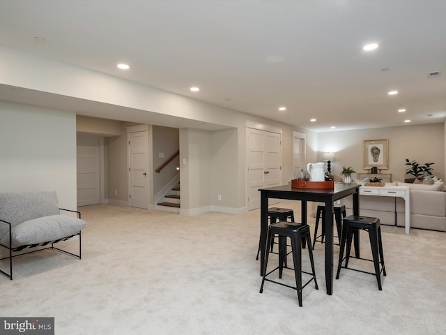 dining room with recessed lighting, baseboards, light carpet, and stairs