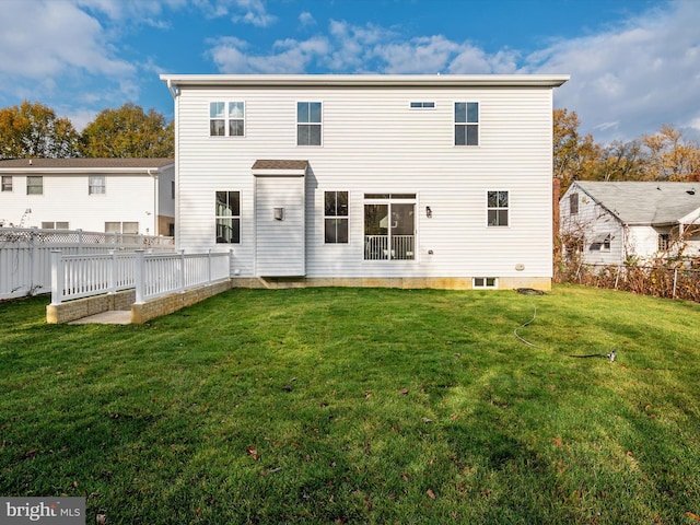 back of property with a lawn and a fenced backyard