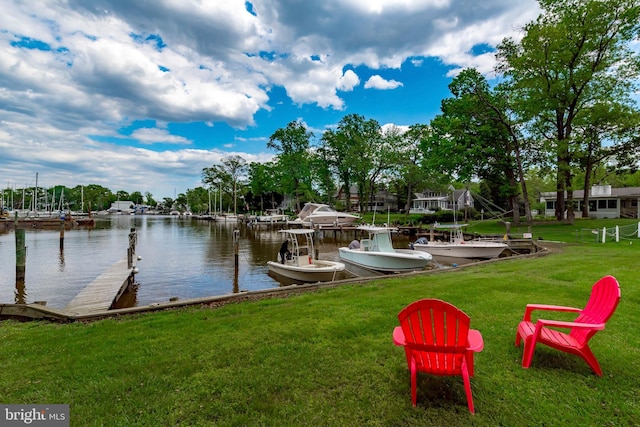 view of dock with a yard and a water view