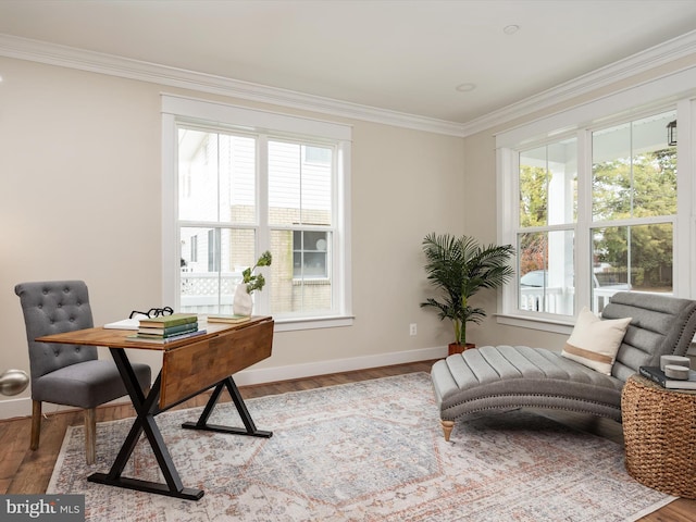 home office featuring crown molding, plenty of natural light, wood finished floors, and baseboards